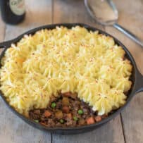 Fluffy and piped mashed potato on top of ground beef and vegetables