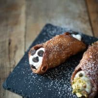 A closeup of a cannoli studded with chocolate chips