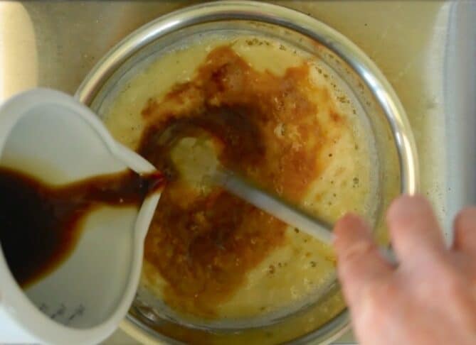 Whisking dark beer into melted butter and flour