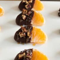 Orange pieces with chocolate, pecans, sea salt and caramel sauce