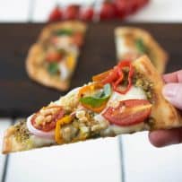 Holding a slice of the flatbread pizza