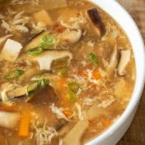 A closeup of the soup showing the mushrooms, tofu and vegetables