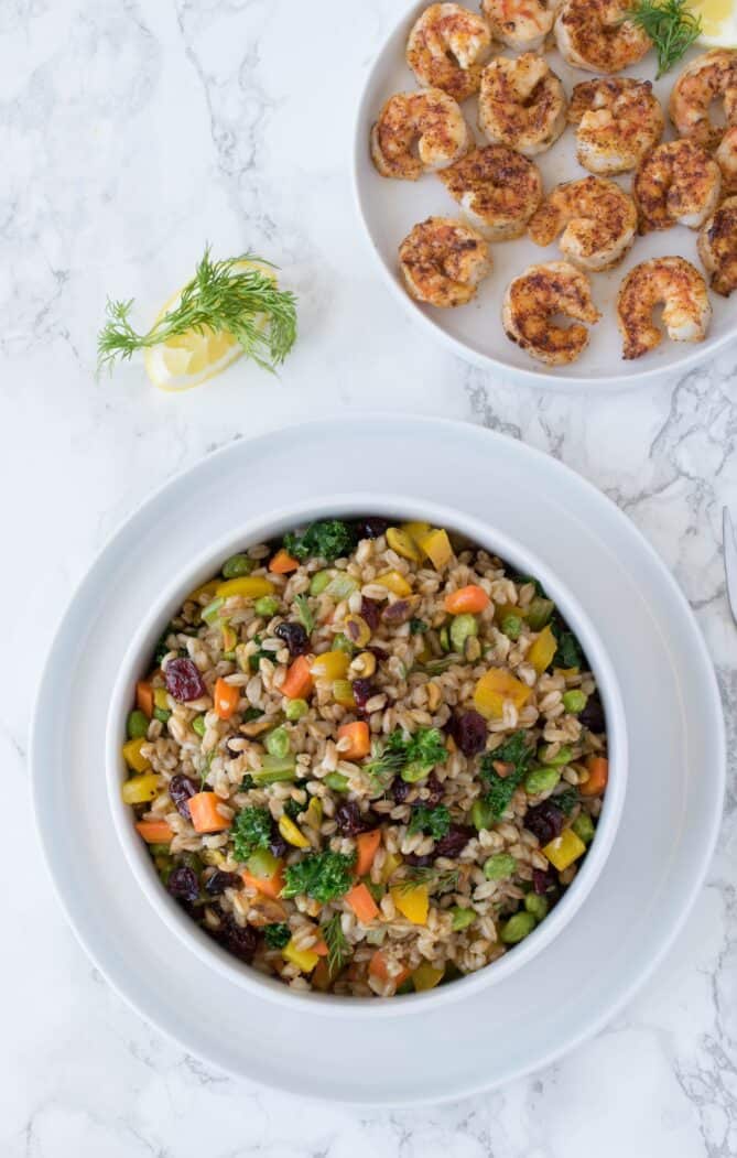Farro mixed with vegetables in a white bowl