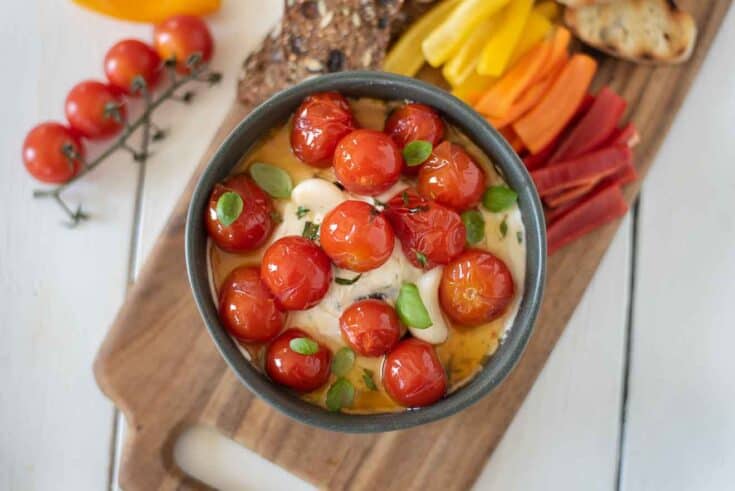 Confit tomatoes on top of whipped ricotta and goat cheese in a bowl