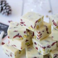 White Chocolate Pistachio Cranberry Fudge squares stacked on top on each other