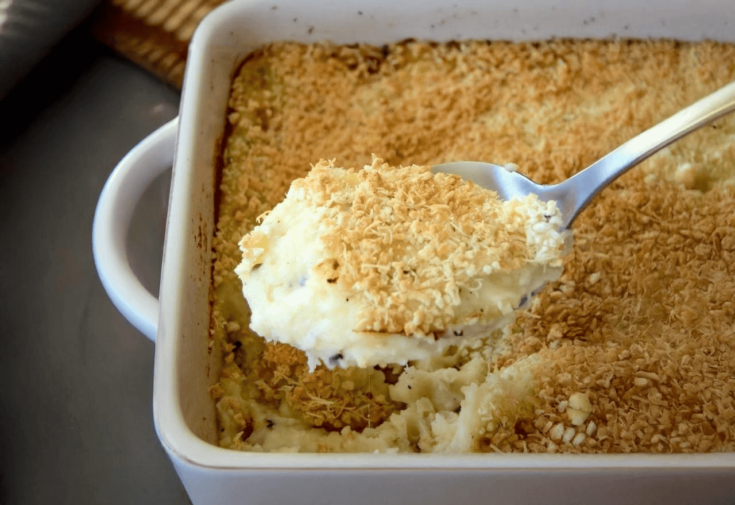 A casserole of mashed potatoes right out of the oven with a browned breadcrumb topping