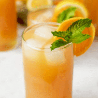 A glass of lemonade and tea with ice cubes and fresh mint