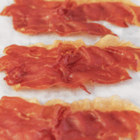 4 slices of prosciutto that has been crisped in the oven
