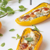 Mini yellow peppers filled with melted blue cheese and hot sauce